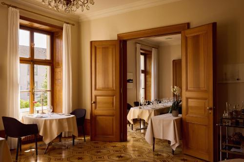 a dining room with tables with white table cloth at Gast - und Kulturhaus Der Teufelhof Basel in Basel