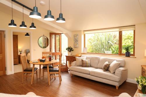 a living room with a couch and a table at Great Western Lodge at Eaton Manor in Eaton