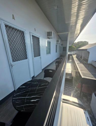 a hallway of a building with tables and chairs at Mamadear's Bed & Breakfast in Suizo