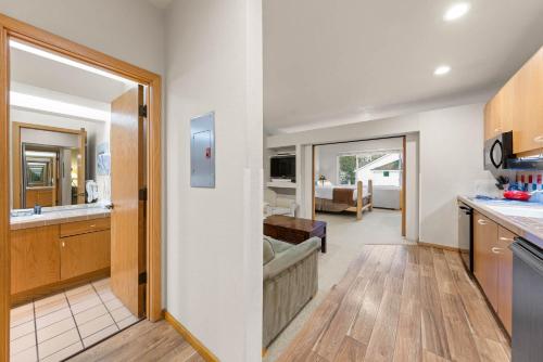 a kitchen and living room with a view of a living room at Palisades Tahoe Lodge Rentals Studio #256 in Olympic Valley