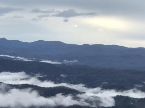 a view of clouds and mountains in the sky at Elkstone Panoramic Views from Blowing Rock to Grandfather in Blowing Rock