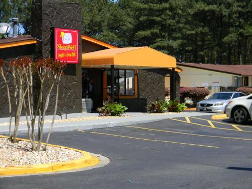 a parking lot in front of a hotel at SleepWell Stockbridge in Stockbridge