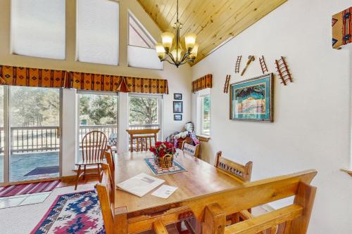 a dining room and living room with a table and chairs at Painted Pony Cabin in Angel Fire