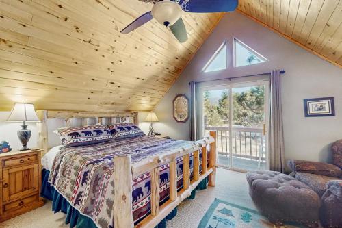 a bedroom with a bed and a wooden ceiling at Painted Pony Cabin in Angel Fire