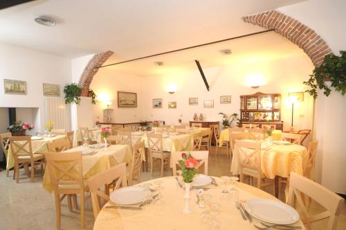 a dining room with white tables and chairs at Hotel Gambone in Finale Ligure