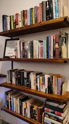 a book shelf filled with lots of books at Coconut Wells Phuket in Chalong 