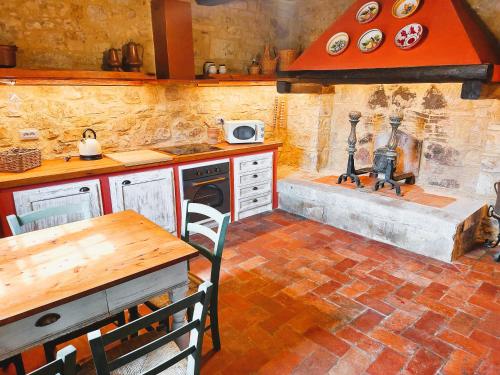 a kitchen with a stove and a stone wall at La Rimbecca Greve in Chianti in Greve in Chianti