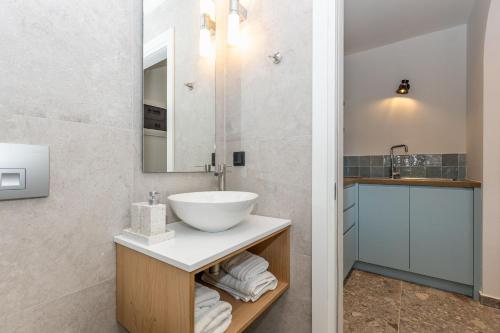 a bathroom with a sink and a mirror at Villa Angelo ΙΙ in Paleokastritsa