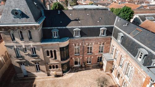 an aerial view of an old brick building at Hotel Castel Jeanson in Ay
