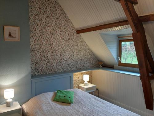 a bedroom with a bed and two night stands at Les Noisettes Sauvages proche Etretat in Villainville