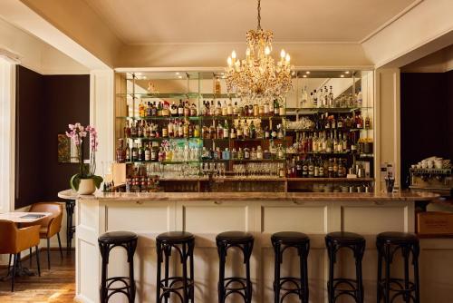 a bar in a restaurant with stools at Gast - und Kulturhaus Der Teufelhof Basel in Basel