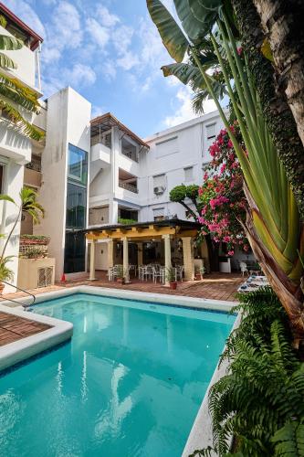 an image of a swimming pool in front of a building at Hotel San Marco  in Santo Domingo