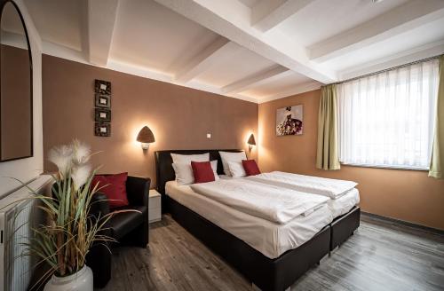 a hotel room with a bed and a couch at Le petit Palais - Hotel/Pension in Bad Suderode