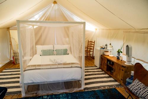 a bedroom with a canopy bed in a tent at Haida Gwaii Glamping in Tlell