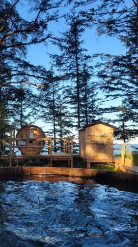 a view of a body of water with trees in the background at Haida Gwaii Glamping in Tlell