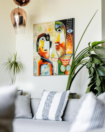 a living room with a couch and a painting at Bavaro Beach Dakhla in Dakhla