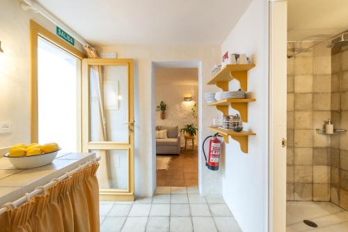 a kitchen with a bowl of fruit on a counter at Romantic Ronda garden cottage in Ronda