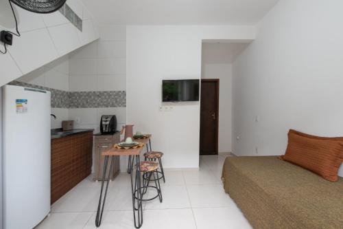 a kitchen and a bedroom with a bed and a table at Morro de São Paulo AP in Morro de São Paulo