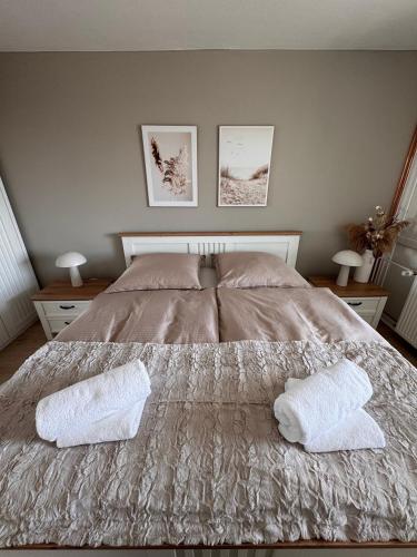 a bedroom with a bed with two pillows on it at Fewo Strandbrise in Eckernförde
