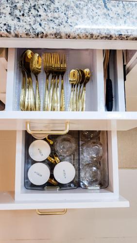 a drawer filled with gold and silver utensils at Isha's Place Self Check-In 2BR Netflix WiFi Camella Homes Villakananga in Butuan
