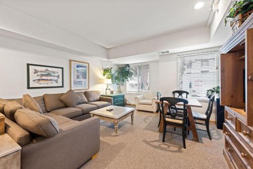 a living room with a couch and a table at Palisades Tahoe Lodge Rentals Studio #111 in Olympic Valley