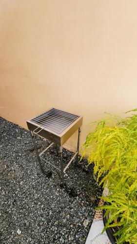 a picnic table sitting on the ground next to a wall at Isha's Place Self Check-In 2BR Netflix WiFi Camella Homes Villakananga in Butuan