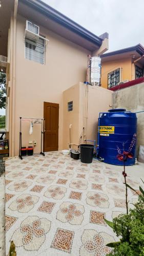 a house with a tile floor in front of a building at Isha's Place Self Check-In 2BR Netflix WiFi Camella Homes Villakananga in Butuan