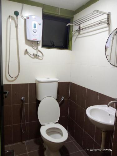a bathroom with a toilet and a sink at D GAYA HOTEL Cameron Highlands in Tanah Rata