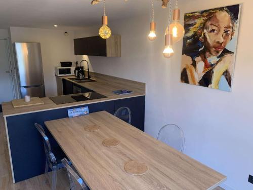 une cuisine avec une table et un tableau mural dans l'établissement Duplex sur le port du Brusc, Plage, Embarcadère, Commerces à pieds, à Six-Fours-les-Plages