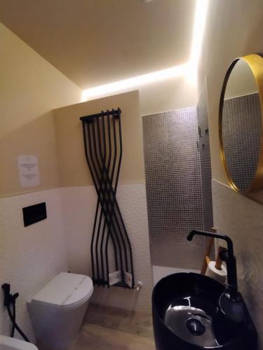 a bathroom with a toilet and a sink and a shower at La Signoria Relais in Ferrara