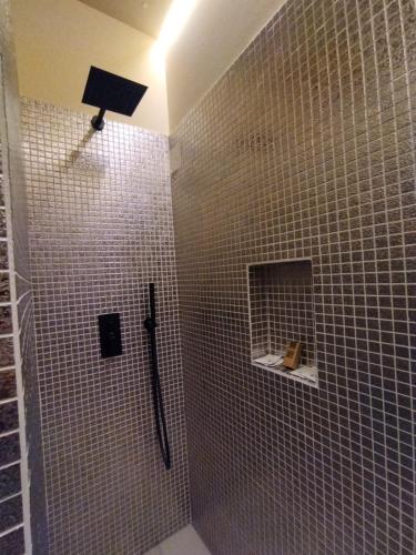 a bathroom with a shower with a black shower head at La Signoria Relais in Ferrara