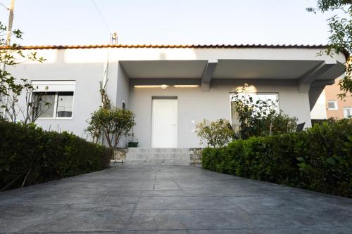 a white house with a driveway at Villa Bregasi in Durrës