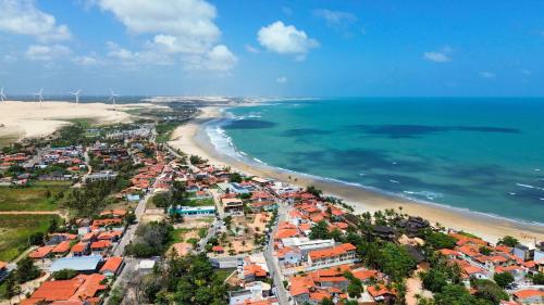 an aerial view of a city and the beach at Bella Spiaggia Suítes in Flecheiras