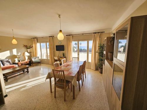 une salle à manger avec une table et des chaises et un salon dans l'établissement A 200 m de la plage, appartement 2 chambres avec terrasse vue mer ! Parking privé, à La Seyne-sur-Mer
