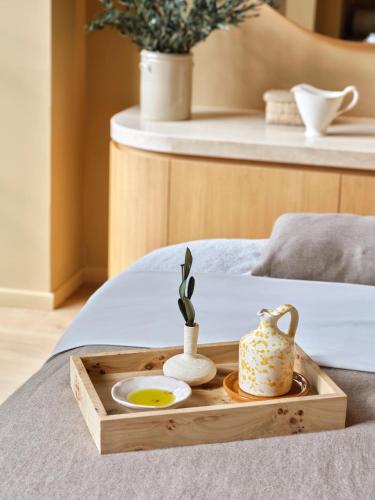 a tray with a tea set on a bed at Collegio alla Querce, Auberge Collection in Florence
