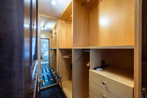 a room with wooden cabinets and two chairs in a room at Palazzo Porta Picta in Bergamo