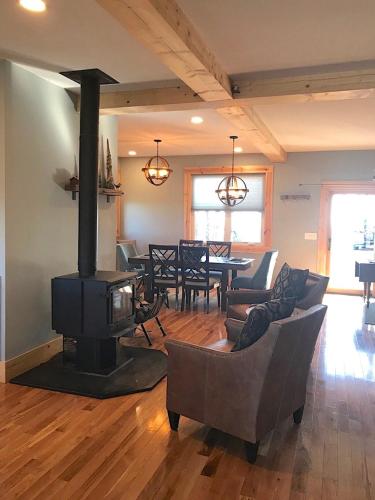 a living room with a fireplace and a dining room at Unique Rustic Barn Theme home Amazing views! Luxe in Bailey Camp