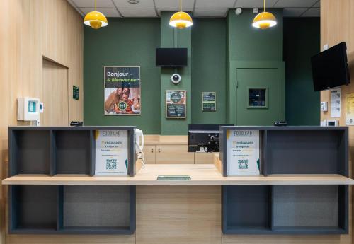 a counter in a store with a cash register at B&B HOTEL Lyon Ouest Tassin in Tassin-la-Demi-Lune
