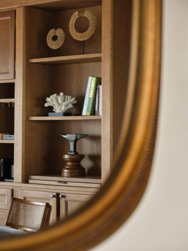 a mirror reflection of a book shelf with books at Collegio alla Querce, Auberge Collection in Florence
