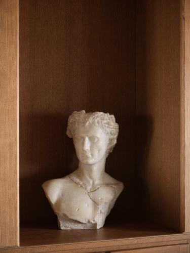a statue of a woman sitting on a shelf at Collegio alla Querce, Auberge Collection in Florence