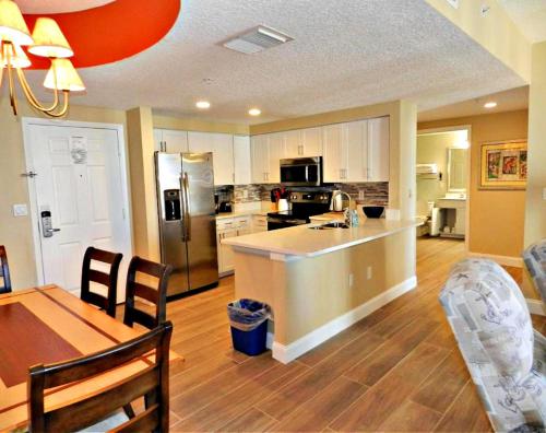 a kitchen and dining room with a table and a counter top at Wyndham Ocean Walk Resort 2332 - Vacation in Comfort and luxury - 2BR Oceanview in Daytona Beach