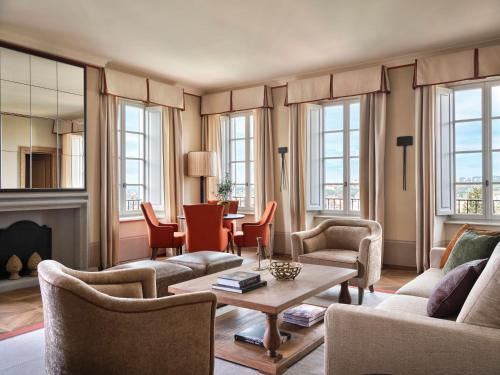 a living room with couches and chairs and a table at Collegio alla Querce, Auberge Collection in Florence