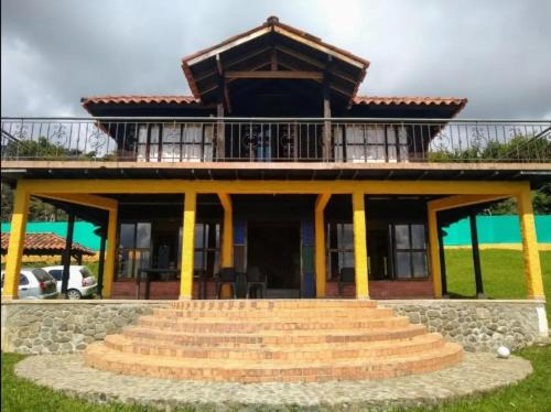 a house with a staircase in front of it at Finca Quinta el chalet in Calima