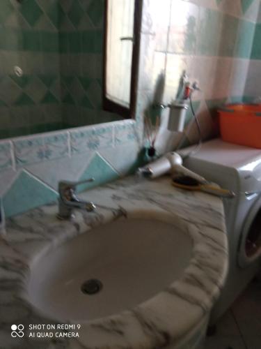 a bathroom with a sink and a toilet at VIA BOCCACCIO 16 in Budoni