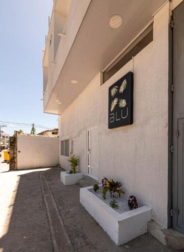 a building with a sign on the side of it at Hotel Blu Sai in San Andrés