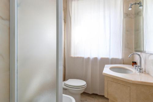 a bathroom with a toilet and a sink and a shower at Dimora Alberoni in Ravenna