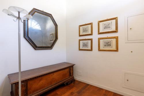 a room with a mirror and a wooden table at Dimora Alberoni in Ravenna