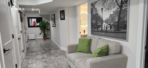 a living room with a couch and green pillows at Entire 2 Bedroom Apartment in Kitchener in Kitchener