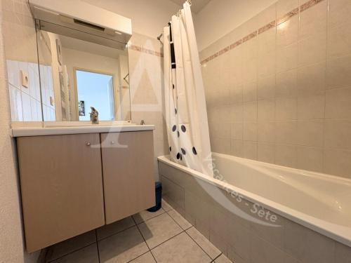 une salle de bain avec une baignoire, un lavabo et une douche dans l'établissement 2 CHAMBRES, PKG, LARGE TERRASSE, PISCINE, VUE PANORAMIQUE MER, à Sète