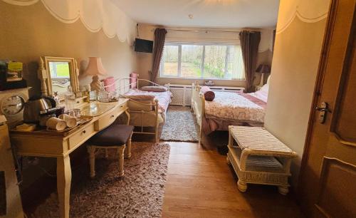 a bedroom with a desk and a bedroom with a bed and a window at Arch House in Florencecourt